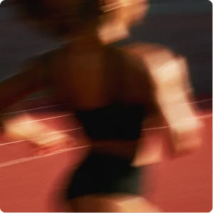 A runner in motion on a red track